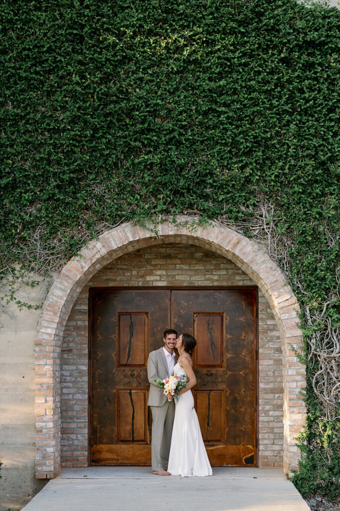 Bride and Groom in front of chapel doors